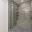 Walk-in shower with small mosaic floor tiles that provide additional traction for safer aging-in-place bathroom design.